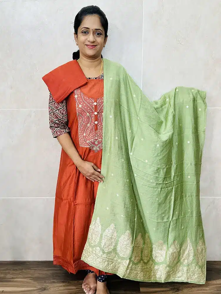 Muslin silk top with embroidered yoke paired with zari weaved muslin silk dupatta and cotton silk bottom