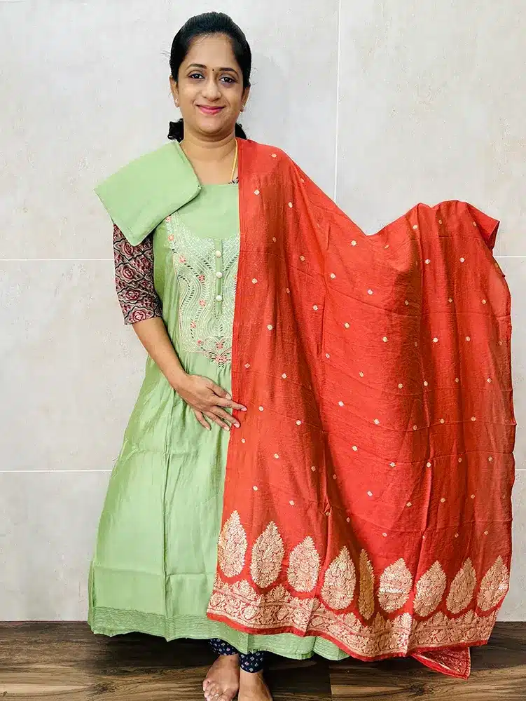 Muslin silk top with embroidered yoke paired with zari weaved muslin silk dupatta and cotton silk bottom