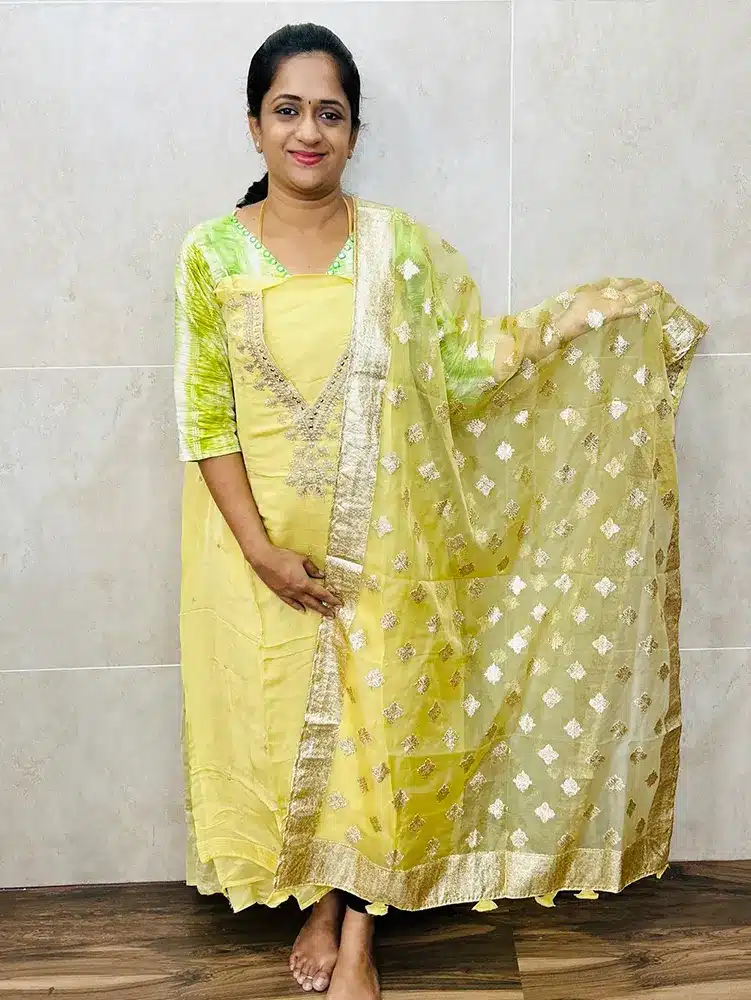 Pure organza top with embroidered yoke paired with zari weaved organza dupatta and cotton silk bottom